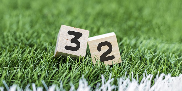 32 Written on Wooden Blocks on Football Pitch
