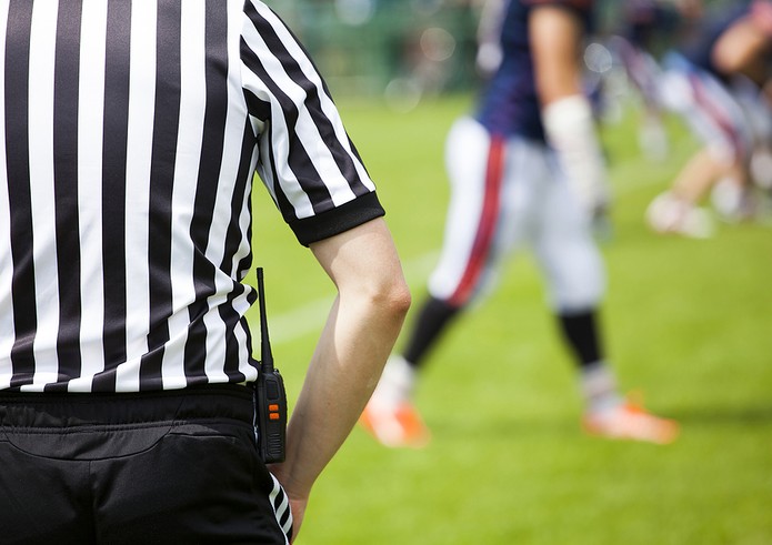 American Football Referee Facing Players