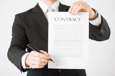 Businessman Holding Up Contract and Pen