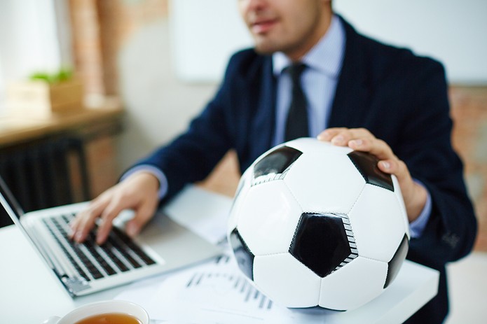 Businessman with Football and Laptop
