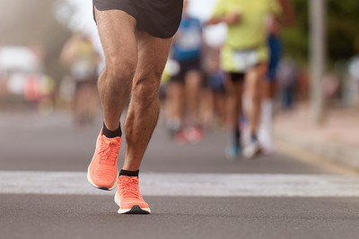 Feet of Marathon Runner at Front of Group