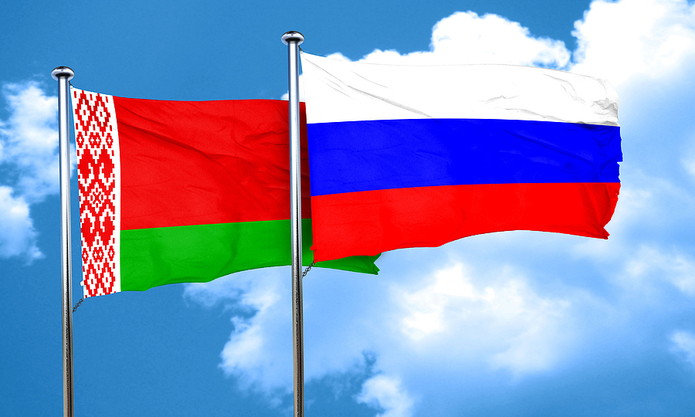 Flags of Russia and Belarus Against Blue Sky