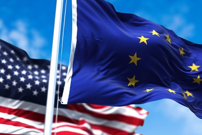 Flags of the EU and USA Waving Against Blue Sky