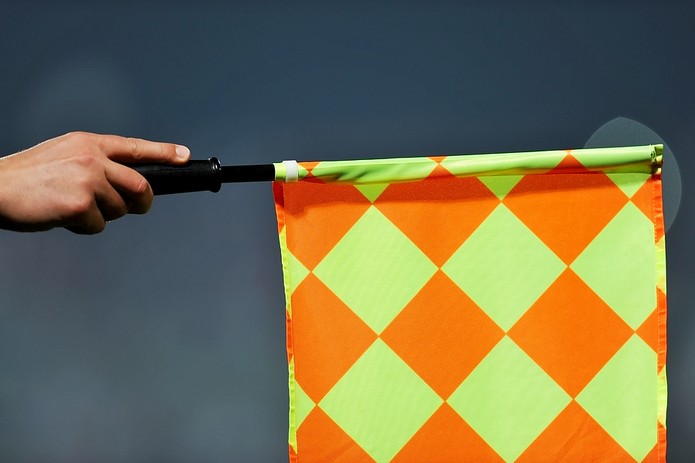 Football Assistant Referee Holding Out Flag
