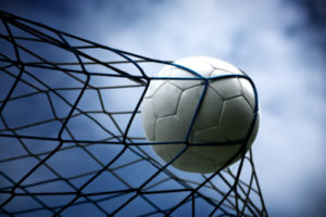 Football Hitting the Back of a Goal Net