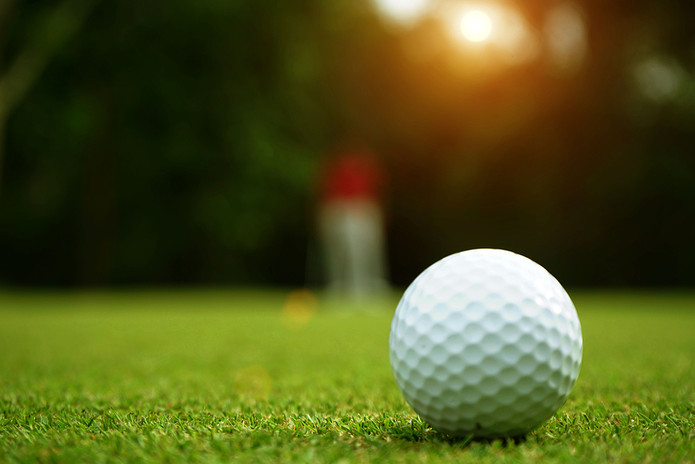 Golf Ball with Blurred Player in Background