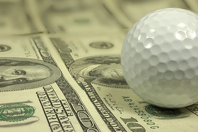 Golf Ball on 100 Dollar Banknotes Close Up