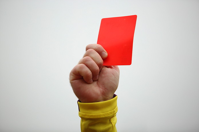 Hand of Referee Holding Card in Air