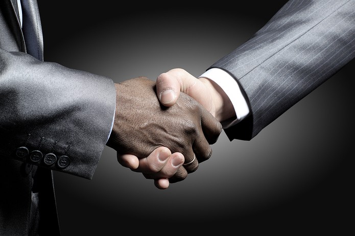 Handshake Between Two Business People in Grey Suits