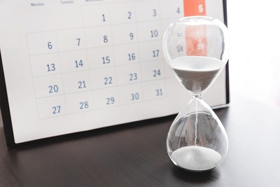 Hourglass on Desk with Calendar