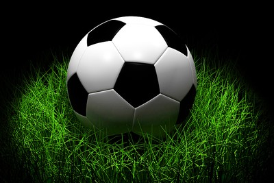 Illuminated Football on Grass Patch