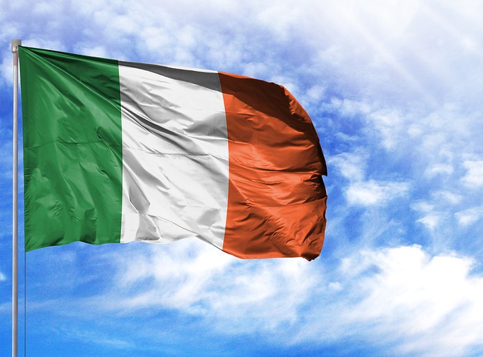 Ireland Flag Against Sunny Cloudy Sky