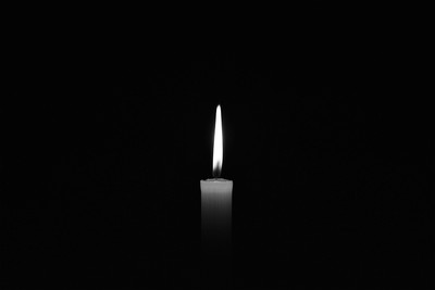 Isolated Candle Against Dark Background