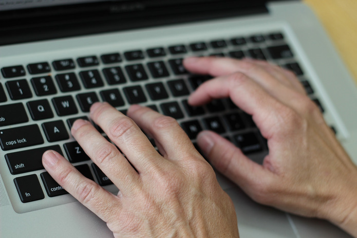 Hands Typing on Keyboard