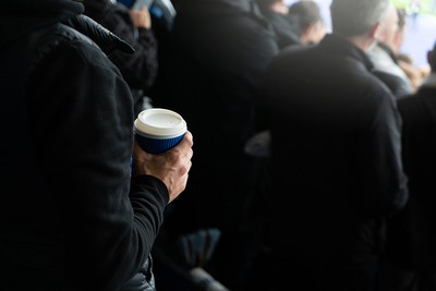 Man Standing with Paper Cup at Football Match