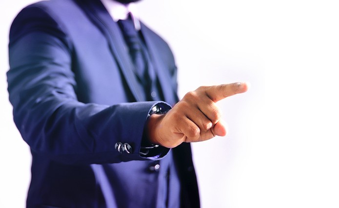 Man in Blue Suit Pointing