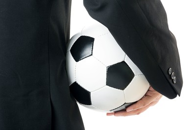 Man in Suit Holding Football