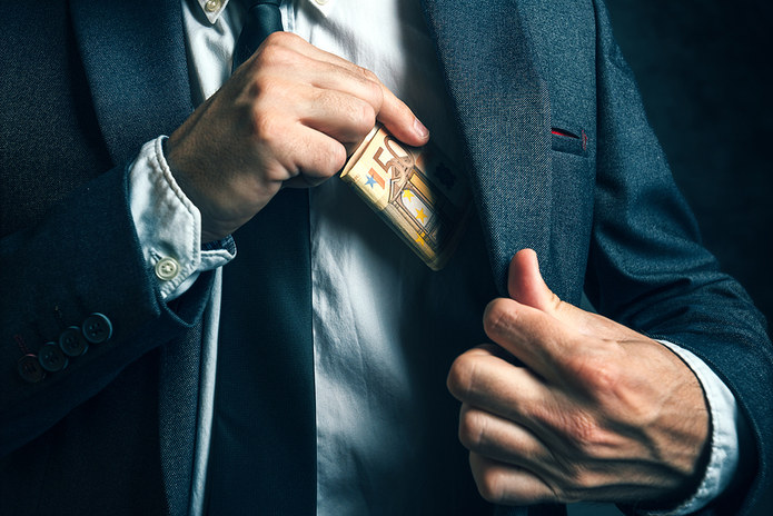 Man in Suit Putting Euro Banknotes in Pocket