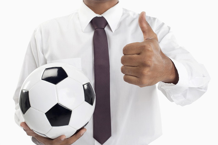 Man with Thumbs Up Holding Football