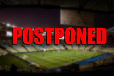 Postponed Text Against Blurred Football Stadium