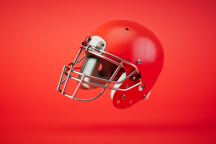 Red American Football Helmet Against Red Background