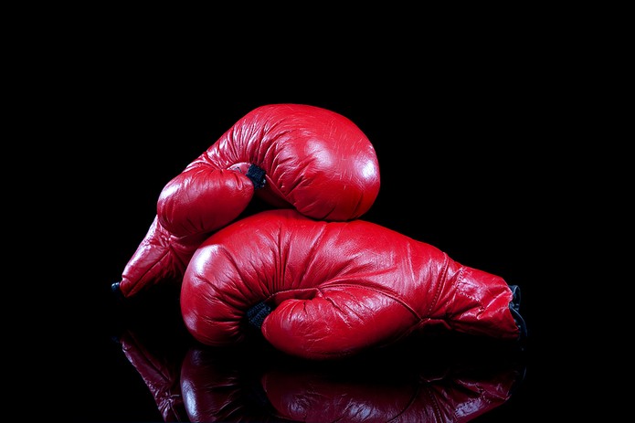 Red Boxing Gloves Against Dark Background