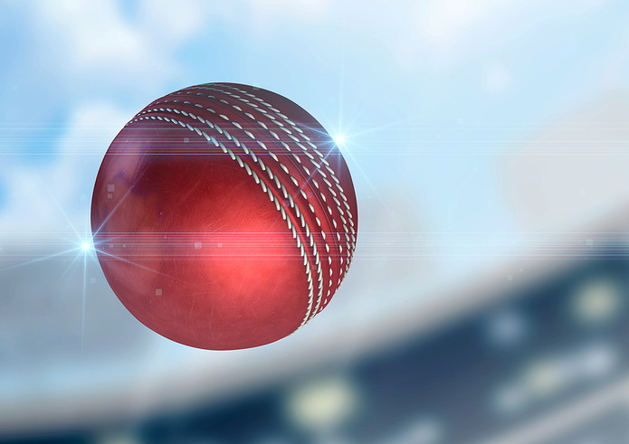 Red Cricket Ball Flying Through Air