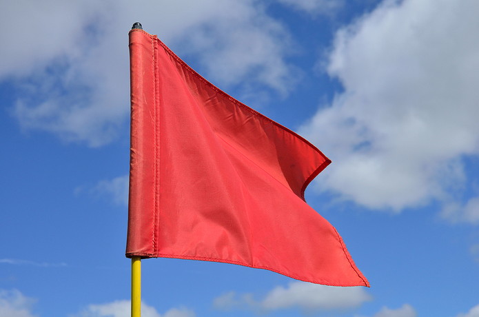 Red Golf Flag in Wind