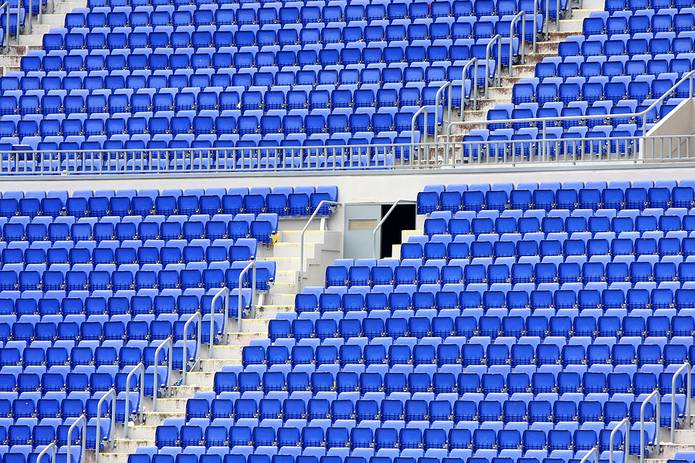 Rows of Empty Blue Seats in Stadium