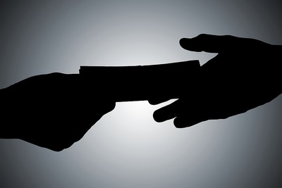 Silhouette of Bribe Changing Hands