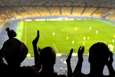 Silhouette of Football Fans Clapping in Stadium