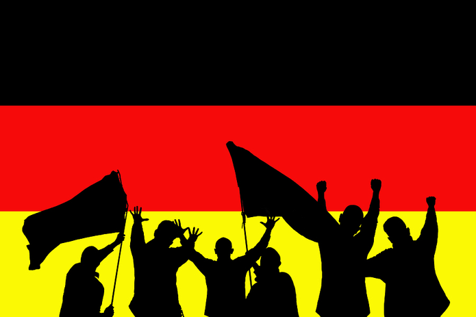 Silhouette of Football fans Against Germany Flag