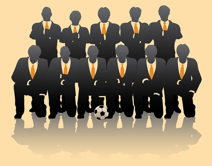 Silhouettes of Business People Posing as Football Team