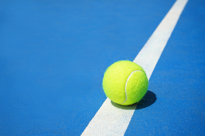 Tennis Ball on Blue Court