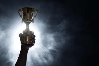 Trophy Held Up Against Dark Background