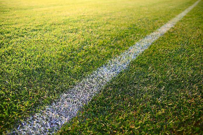 White Line Painted Across Grass Football Pitch