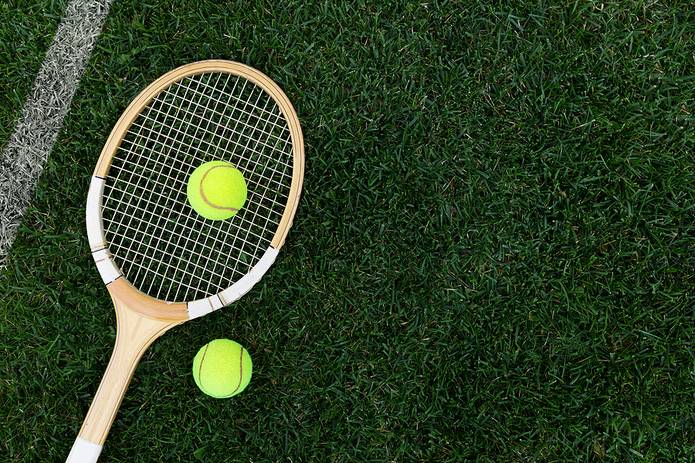 Wooden Tennis Racquet on Grass