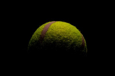 Yellow Tennis Ball in Darkness
