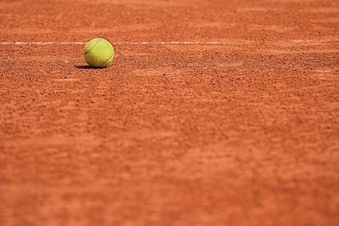Yellow Tennis Ball on Clay Court